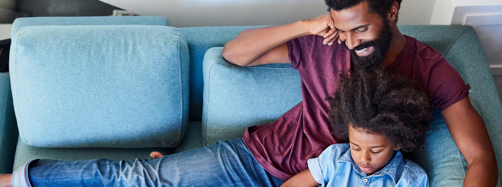 parent and child sitting on couch